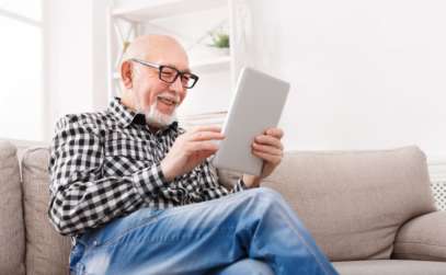 an elderly man using an ipad