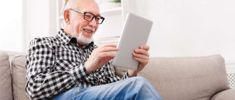 an elderly man using an ipad