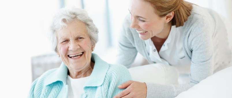 caregiver and senior sharing a laugh