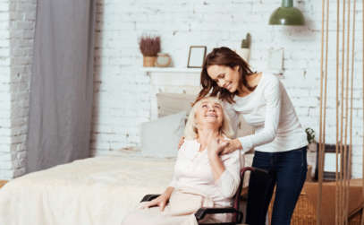 a caregiver assisting an elderly lady in a wheelchair