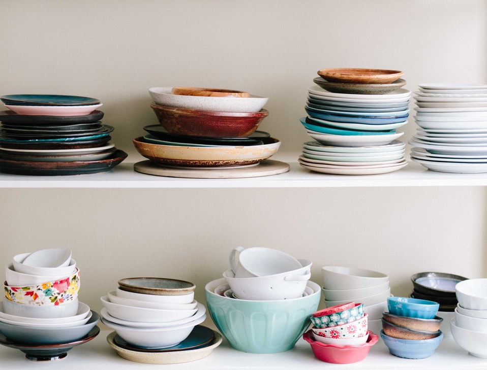 a cupboard full of plates and bowls