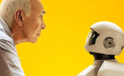 an elderly man looking face to face at a robot