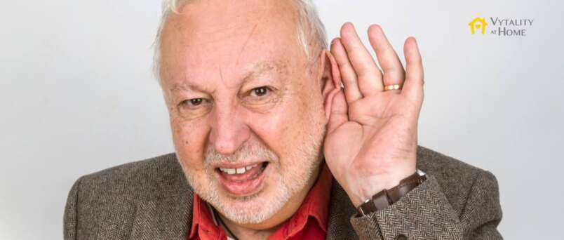 Senior man with hand to ear for hearing loss